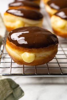 chocolate covered donuts cooling on a wire rack