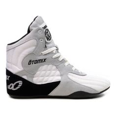 a pair of white and black sneakers with the word dmx written on the side