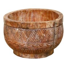 a large wooden bowl with intricate designs on the rim and sides, isolated against a white background