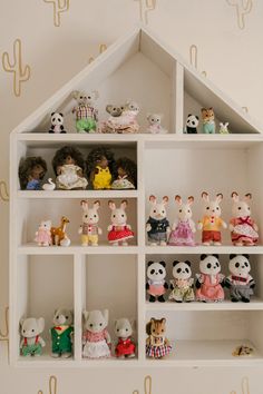 a white shelf filled with lots of stuffed animals on top of it's sides