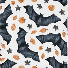 an artistic tile design with leaves and stars on the ground in black, white, and orange colors