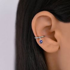 Conch hoop earring with a evil eye charm. There are different charms to choose from. The charms on this conch piercing are detachable. Huggie Hoop - surgical stainless steel (18 gauge) Charm - sterling silver 925 Shipped with tracking number Conch Piercing Hoop Silver, Conch Ring Silver, Silver Conch Hoop, Thick Conch Hoop, Hoop Conch Piercing, Conch Piercing Hoop, Girly Jewelry Peircinhx Conch, Conch Piercings, Conch Hoop