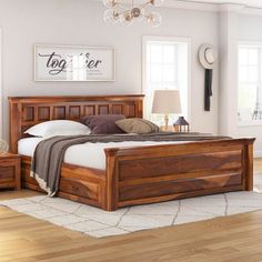 a bed room with a neatly made bed and two night stands