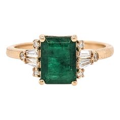 This gorgeous ring features a 1.5 carat emerald cut emerald with natural earth mined diamonds, all set in solid 14K gold. This ring can be a beautiful birthstone gift for your loved ones!   Fun fact: Emerald is the birthstone of all who are born in the month of May!  Specifications  Item Type: Ring Center Stone: Emerald Treatment: Oiled Weight: 1.5ct Head size: 8x6mm Shape: Emerald cut Hardness: 7.5-8  Metal: 14k/2.32g Diamond Clarity/Color: SI / G-H Diamond Count/Weight: 10/0.22 cttw  SKU: AJR1129/2312  This ring is made with solid 14K Gold and natural Earth mined SI / G-H diamonds.  As listed, this ring is ready to ship.   length: 8 mm width: 6 mm   ***We offer complimentary resizing, message us the size you need.  WARRANTY: A one year warranty is offered with all purchases! **Please not Antique Emerald Engagement Ring, Antique Emerald Ring, Emerald Engagement Ring Green, Vintage Emerald Engagement Ring, White Engagement Ring, Green Sapphire Engagement, Emerald Ring Vintage, Green Sapphire Engagement Ring, Emerald Wedding Rings