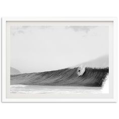 a black and white photo of a large wave