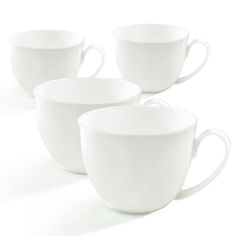 four white coffee cups sitting next to each other