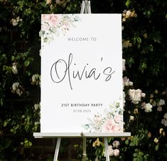 a welcome sign with flowers on it in front of some bushes and shrubbery that reads, julia's 21st birthday party