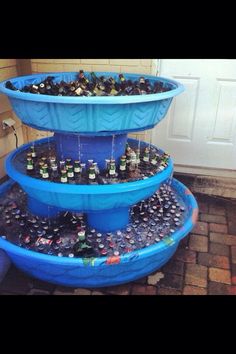 three tiered water fountain filled with beer bottles