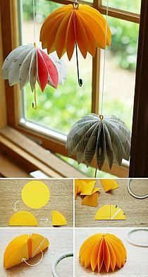 several pictures of different types of paper flowers hanging from strings and on the windowsill