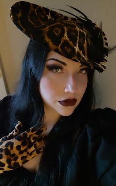 A stunning velvet Leopard Print Hat with various feathers and adornments. Be the center of attention in this elegant Hat. Made in a pet friendly studio. 3 to 5 days creation time. Please check out my other listings: Black Velvet Victorian with Tassels: https://www.etsy.com/listing/1197594531/black-velvet-formal-hat-velvet-top-hat Silver Victorian: https://www.etsy.com/listing/1293744756/victorian-hat-edwardian-hat-downton Mauve Victorian:  https://www.etsy.com/listing/1293745798/mauve-velvet-hat-formal-hat-red-top-hat Burgandy Victorian:  https://www.etsy.com/listing/1094341893/victorian-hat-edwardian-hat-downton Turquoise Peacock: https://www.etsy.com/listing/1101444884/turquoise-peacock-hat-top-hat-formal-hat The Winifred:  https://www.etsy.com/listing/1285323620/the-winifred-hat-victori Evening Costume Hat With Feathers, Evening Mini Hat With Feather Trim And Curved Brim, Wide Brim Feathered Fascinator, Feathered Wide Brim Costume Hats For Evening, Vintage Mini Hats With Curved Brim For Costume Party, Vintage Headpieces For Costume Party, Vintage Feathered Hats, Elegant Costume Hat With Curved Brim, Elegant Curved Brim Hats For Costume Party