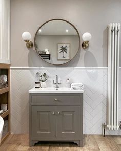 a bathroom with a sink, mirror and bathtub in it's center area