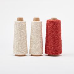 three spools of thread sitting next to each other