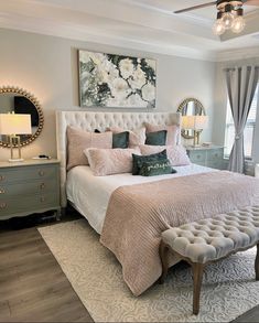 a bedroom with a bed, dressers and mirror in it's center area