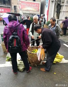 people are standing on the street with baskets full of fruit