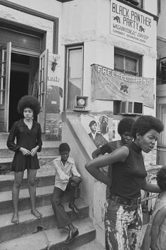 black and white photograph of people standing on steps