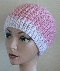 a mannequin head wearing a pink and white knitted hat with stripes on it