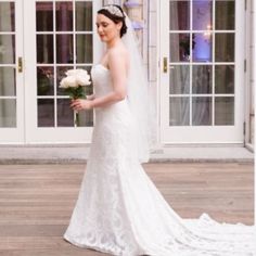 a woman in a wedding dress holding a bouquet