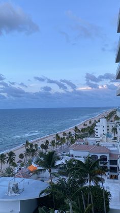 an ocean view from the balcony of a hotel in miami beach, floriganized with palm trees