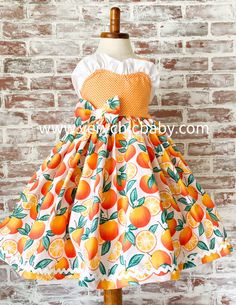 This sweet dress is perfect for your orange themed party or photoshoot! It has a twirling skirt trimmed in ricrac and a reverse knot bodice with the cutest detailing. We typically recommend ordering the size corresponding with age for the best fit. This dress is made to be worn at an above the knee vintage length. Playful Orange Sleeveless Dress, Playful Orange Dress For Spring, Playful Orange Spring Dress, Orange Ruffled Dress For Dress-up, Orange Ruffled Dress For Dress-up Occasions, Orange Cotton A-line Dress, Orange A-line Cotton Dress, Orange Ruffled Dress For Garden Party, Orange Sleeveless Dress With Ruffle Hem