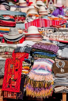 hats and scarves for sale at an outdoor market