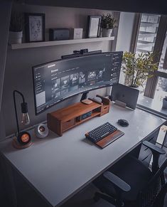 a computer monitor sitting on top of a white desk next to a keyboard and mouse