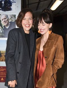 two women standing next to each other smiling