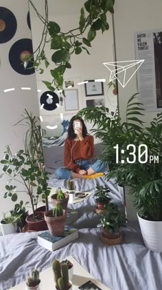 a woman sitting on a bed surrounded by potted plants and listening to headphones