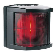 a red light that is on top of a black stand