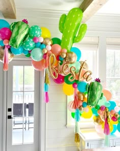 balloons and tassels decorate the entrance to a home decorated for a new year's eve celebration