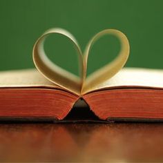 an open book with a heart shaped pages