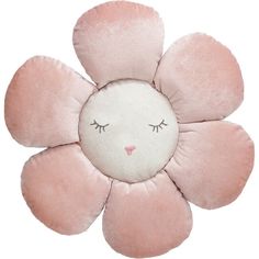 a pink flower shaped pillow with eyelashes on it's face and one eye closed