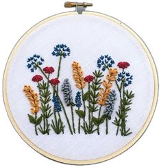 a white embroidery hoop with colorful flowers on it