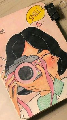 a drawing of a woman taking a photo with her camera on a notepad next to a pen