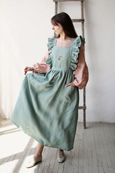 "Long vintage apron is made from 100% soft and washed medium weight linen.  Details: - Colour: Mint - Composition: 100% Oeko-Tex certified linen - Cross back - Flutter sleeves - Adjustable with buttons - Size: One size - Medium weight linen - Linen care: machine wash gentle; tumble dry low, ironing optional - The price is for one apron, other pictured items are not included The model is 170 cm/5'7\" and wears a size one size." Victorian Maid, Linen Pinafore, Cross Back Apron, Baking Apron, Old Fashion Dresses, Apron Dress, Aprons Vintage, Womens Aprons, Linen Apron