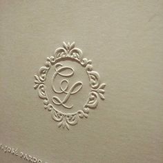 the monogrammed initials on this wedding album are embellished