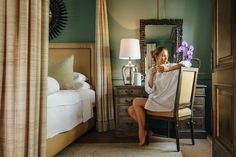 a woman taking a selfie in her hotel room