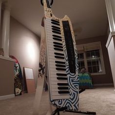 an old piano sitting on top of a stand in the middle of a living room