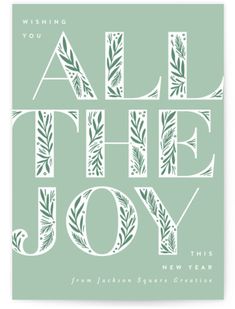 an all the joy christmas card with white lettering and green leaves on a light green background