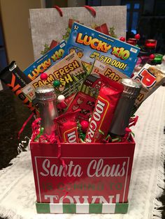 a red box filled with lots of candy and candies sitting on top of a table