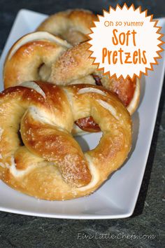 two soft pretzels on a white plate with an orange sticker over the top