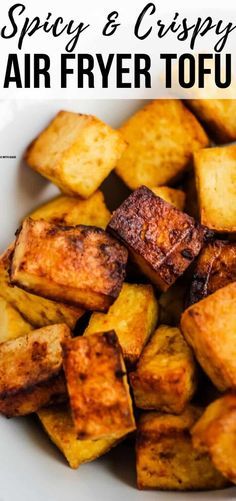 a white plate topped with fried tofu and text spicy & crispy air fryer tofu