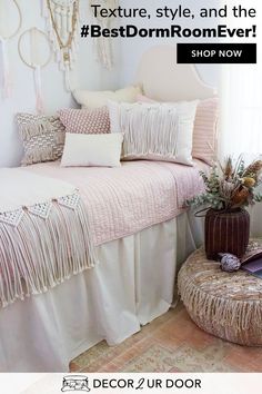 a bed with pink and white pillows on top of it, next to a window