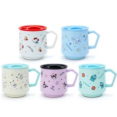 four different colored coffee mugs sitting next to each other on a white surface with cartoon characters