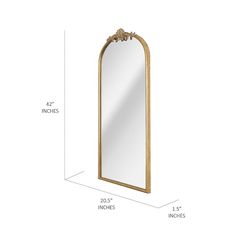 the measurements for a large mirror with an arch shaped frame and gold trimmings