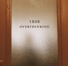 the door to an office building has a etched sign that reads 1088 overthiking