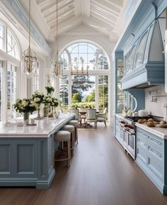 a large kitchen with blue cabinets and white counter tops, along with an island in the middle