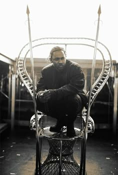 a man sitting on top of a metal chair