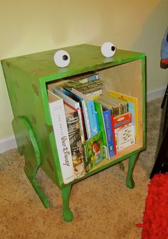 a green bookcase with two eyes on it