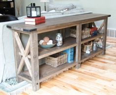 the table is made out of wood and has an entertainment center on one side with shelves