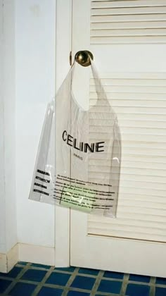 a plastic bag hanging from the side of a door with an ad for celline on it